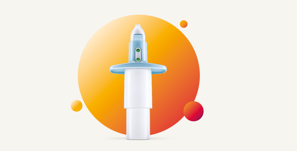 Close-up of the Spravato (esketamine) nasal spray device with an orange circular gradient background.